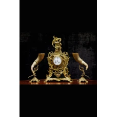 Antique clock of mantel with two animal horn vases 