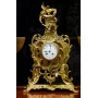Antique clock of mantel with two animal horn vases 