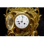 Antique clock of mantel with two animal horn vases 